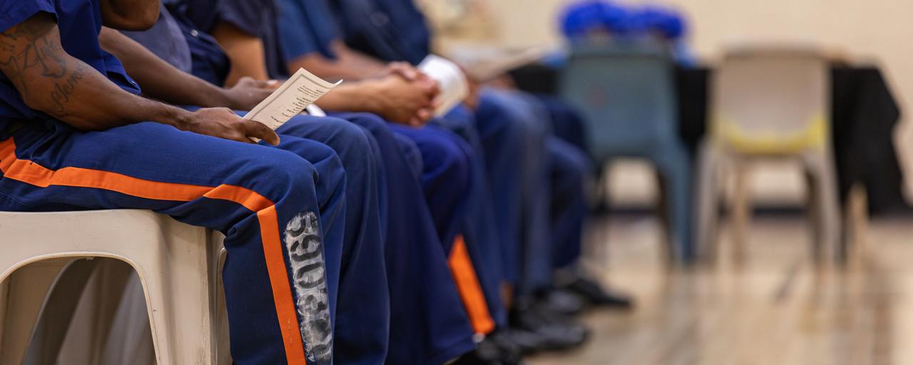 Students seated, holding convocation programs